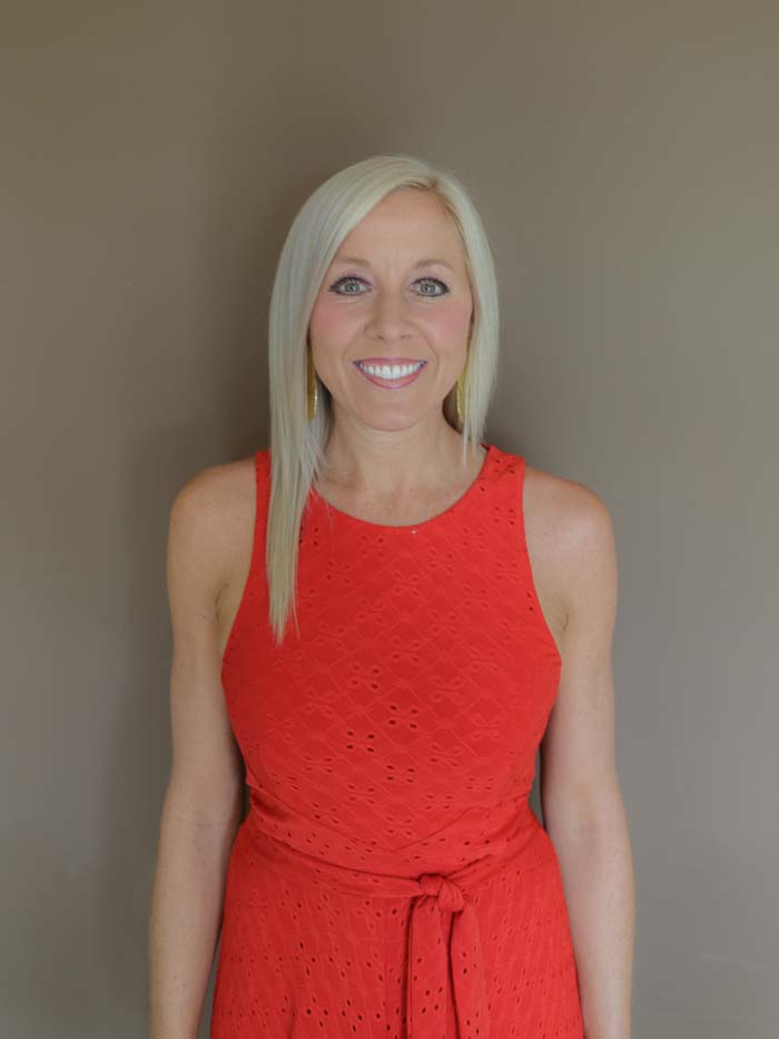 Dr. Jane Bennett smiling in a red dress